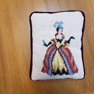Decorative needlepoint throw pillow.